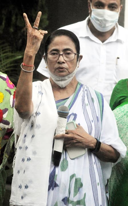 TMC party candidate and West Bengal Chief Minister Mamata Banerjee flashes victory sign as she leads in Bhawanipur Assembly by-polls in Kolkata, Sunday, Oct 3, 2021. (PTI Photo)