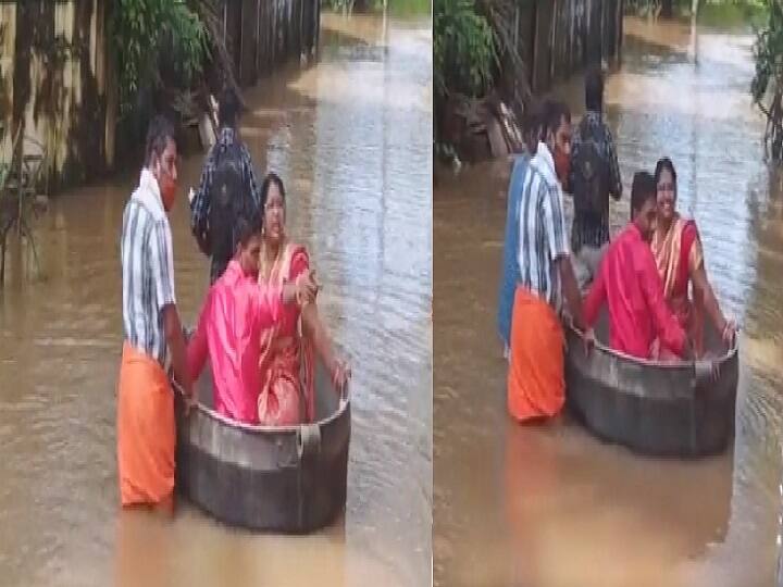 kerala couple uses cooking vessel to wade through flood waters in Alappuzha district viral video Watch Video | சுற்றிலும் வெள்ளம்.. பாத்திரத்தை படகாக்கி திருமணத்தை நடத்திய ஜோடி..