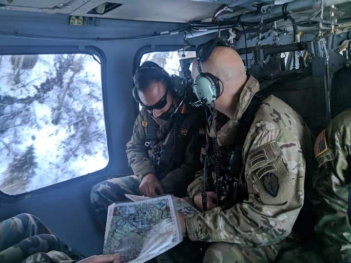 Indian and US Soldiers in UH 60 Blackhawk helicopter taking an aerial reconnaissance of the target objective for the validation exercise. (Source: ANI)