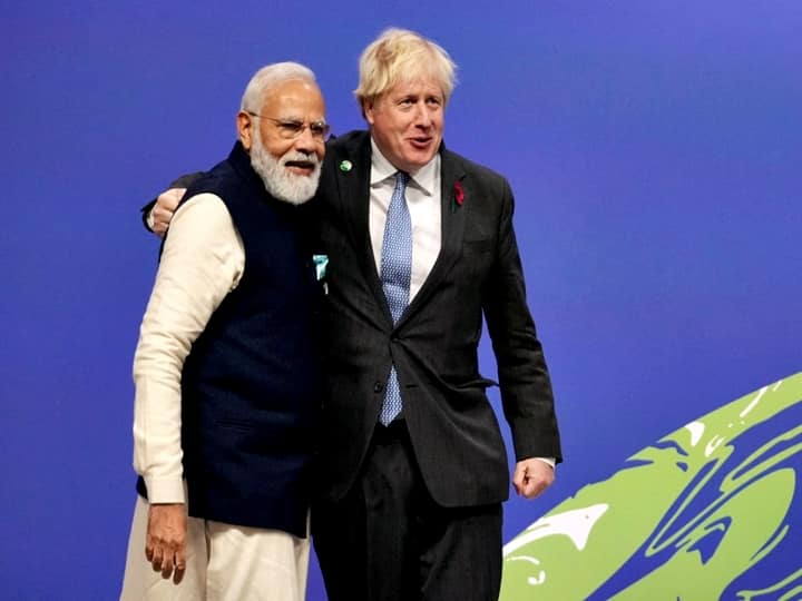 Britain's Prime Minister Boris Johnson greets Prime Minister Narendra Modi as they arrive to attend the COP26 UN Climate Change Conference in Glasgow, Scotland on November 1, 2021. (Photo by Christopher Furlong / POOL / AFP)