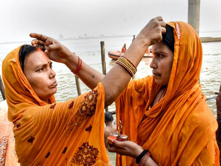 Women pray for a good harvest, family health, and prosperity, and for the long life of children. In this photo, devotees apply vermillion to each other while taking bath in the holy Ganga river on the occasion of the Chhath Puja festival in Patna, Monday, Nov. 8, 2021. (PTI Photo)