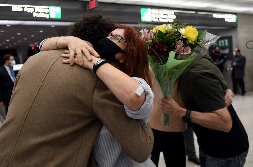 Couple embraces each other as they see each other for the first time since Covid-19 related restrictions were implemented. Courtesy: AFP