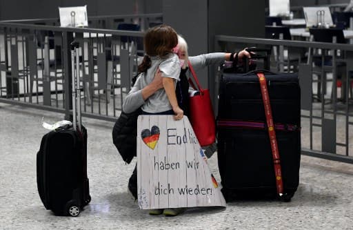 A woman hugs her granddaughter as she sees her for the first time in 20 months. Courtesy: AFP