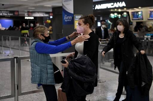 Woman hugs her daughter upon arrival of a flight from Amsterdam. The restrictions were lifter on November 8 after a long wait for people across the borders. Courtesy: AFP