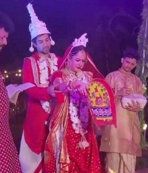 The couple performing a ritual ahead of pheras.
