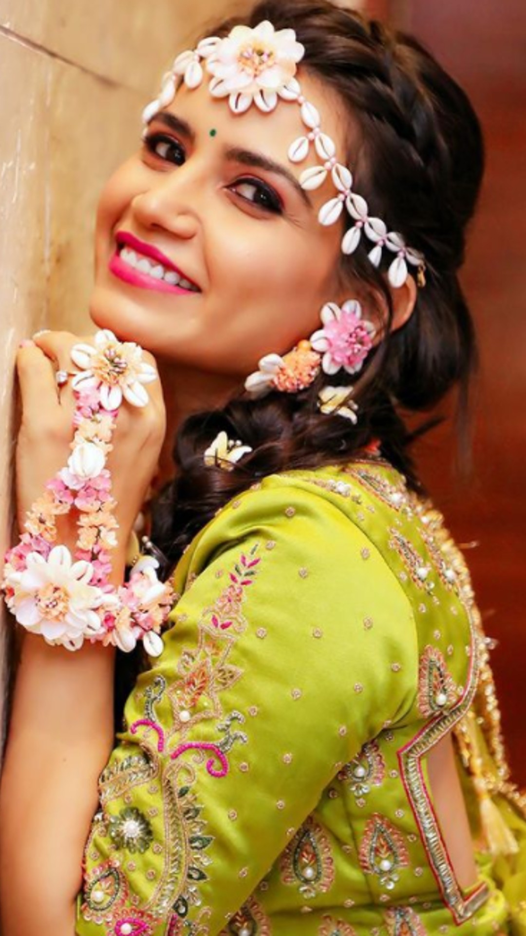 Photo of pastel pink bridal lehenga with unique blouse and green jewellery