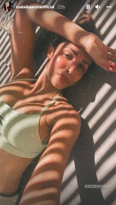 Malaika can be seen sunbathing in a mint-green bikini.