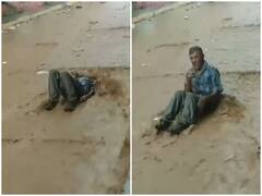 Watch: पानी से डूबी सड़क में नशे की हालत में पड़ा था शख्स, अचानक से उठा और...