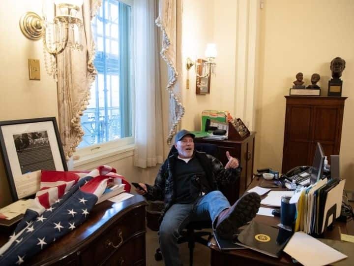 Richard Barnett, a supporter of former US President Donald Trump, sits inside the office of then US Speaker of the House Nancy Pelosi during a protest inside the US Capitol in Washington, DC, on January 6, 2021. Demonstrators breached security and entered the Capitol as Congress debated the 2020 presidential election’s Electoral Vote Certification | Photo: AFP