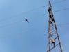 Electricity Tower: ఇదేమైనా బాగుందా.. స్వీట్స్, సెల్ ఫోన్ కావాలంటే షాప్ వెళ్లు.. విద్యుత్ టవర్ పైకి ఎందుకు?
