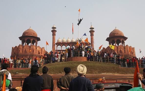 Farmers' Republic Day Violence: Nishan Sahib or Sikh religious flags hoisted near the Indian tricolour at Red Fort during the farmers' tractor rally on Republic Day, on January 26, 2021 in New Delhi, India. A large number of protesters deviated from the designated route for the proposed tractor parade in the national capital and barged into the Red Fort. They were later removed by the police. (Image: Getty Images)