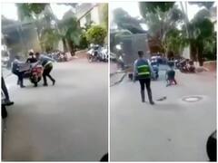 Watch: स्कूटी चला रही लड़की को रोकने की कोशिश में गिरा पुलिसकर्मी, वीडियो हुआ वायरल