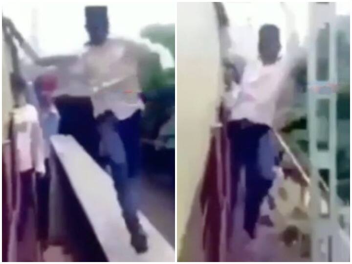 Man doing stunt with fast running train video goes viral Watch: चलती ट्रेन से लटककर शख्स ने किए दिल दहला देने वाले स्टंट, देखने वालों की थमीं सांसें