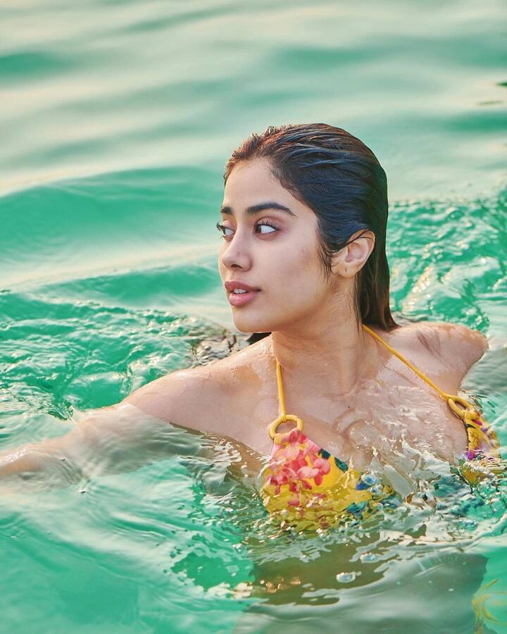 Janhvi Kapoor can be seen happily posing for the camera as she picked floral swimwear for her pool day.