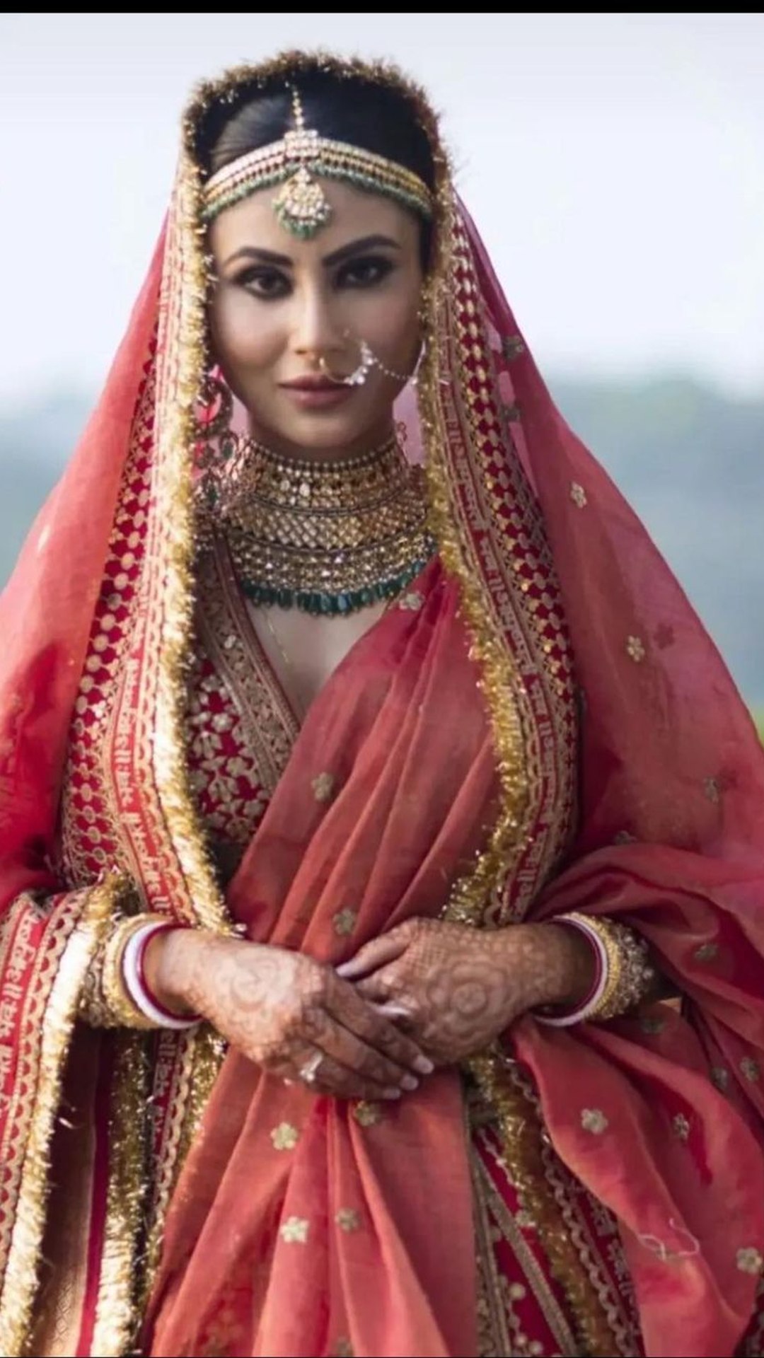 Photo of Bridal portrait with contrasting jewellery and red lehenga