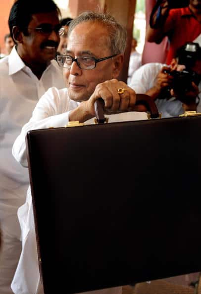 Finance Minister Pranab Mukherjee holds up a briefcase containing annual budget documents as he arrives in Parliament to present the Union Budget in New Delhi on July 6, 2009. (Getty Images)