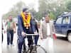 UP Election 2022: खराब मौसम के बीच साइकिल से नामांकन पत्र भरने पहुंचे सपा उम्मीदवार, जानें- क्या कहा?