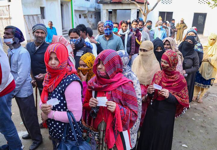 Voters lined up in a queue outside a polling booth | Courtesy: PTI