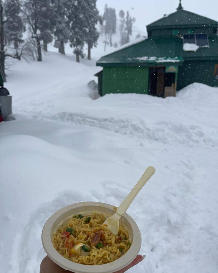Mouni Roy took to Instagram to share a series of photos in the snow-capped mountains of Kashmir. She also shared a photo of a bowl full of delectable maggie writing, 