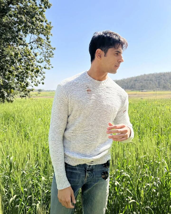 Sidharth looked dashing in his clean-shaved appearance. He's dressed in a white ripped sweater and denim, with his sunglasses tucked into his pockets.