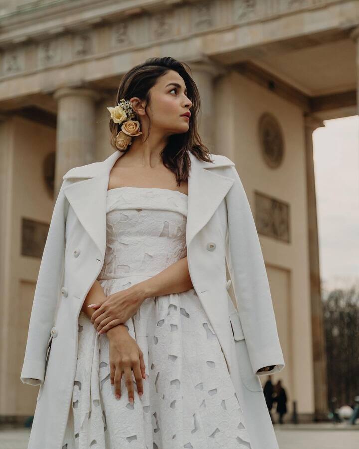 Her makeup is fresh, dewy and simple with rosy cheeks. Apart from pastel-hued roses on her hair, she wore no further accessories. (Image: Instagram/stylebyami)