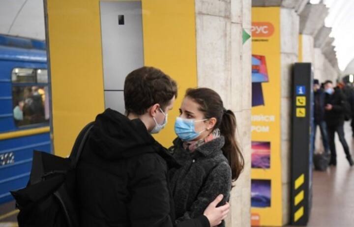 A couple speaks with each other at a metro station in Kyiv early on February 24, 2022. Russian President Vladimir Putin announced a military operation in Ukraine on Thursday with explosions heard soon after across the country and its foreign minister warning a