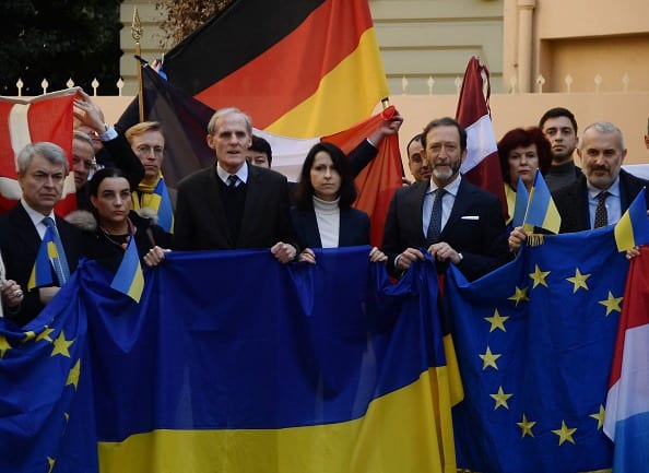 French ambassador Christian Masset (third from left), German ambassador Viktor Elbling (third from right) and Ukraine vice ambassador Oxana Amdzhadin (fourth from right) together with European diplomatic personnel hold a Ukraine flag during a demonstration in support of Ukraine in front of the country's embassy in Rome on February 24, 2022. (Photo: Getty Images)