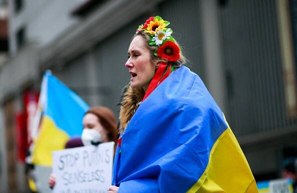Demonstrators protest in support of Ukraine, in Times Square New York, on February 24, 2022. Russian President Vladimir Putin launched a full-scale attack on Ukraine on Thursday, unleashing air strikes and ordering ground troops across the border in fighting that Ukrainian authorities said left dozens of people dead. (Photo: Getty Images)