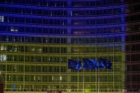 Illustration picture shows European flags fly in front of the Berlaymont building, housing the European Commission headquarters, that has been illuminated in the colours of the Ukrainian flag, to show support for the Ukrainian people, in Brussels. (Photo: Getty Images)