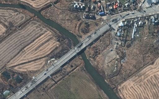 This Maxar satellite image taken and released on February 28, 2022, shows a damaged bridge and destroyed armored vehicles in Irpin, western Kyiv, Ukraine | Satellite image ©2022 Maxar Technologies / AFP