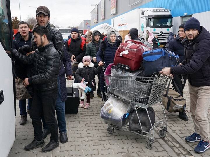 Following the invasion, Ukrainian civilians have been fleeing the country leading to a refugee crisis in its neighbouring countries. Refugees from Ukraine queue to a bus to further destinations at the distribution centre in Korczowa, Poland, on March 5, 2022. Almost 1.37 million refugees have fled Ukraine in the week since the invasion, with over half going into Poland, according to the UN refugee agency. (AFP)
