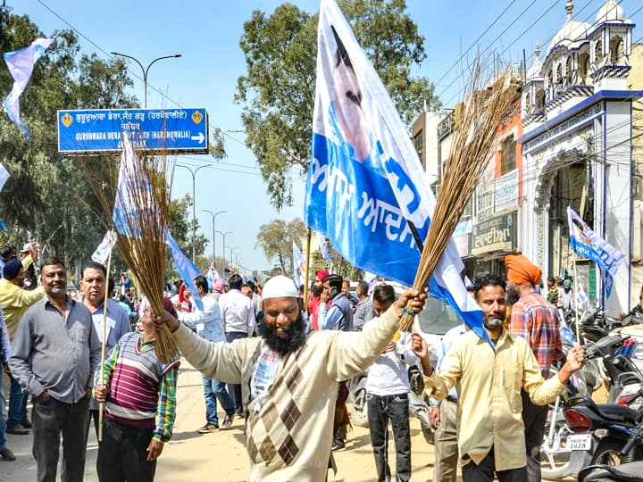 Aam Aadmi Party (AAP) supporters celebrate their partys lead during the counting day of Punjab Assembly elections, in Jalandhar district, Thursday, March 10, 2022. (PTI Photo)