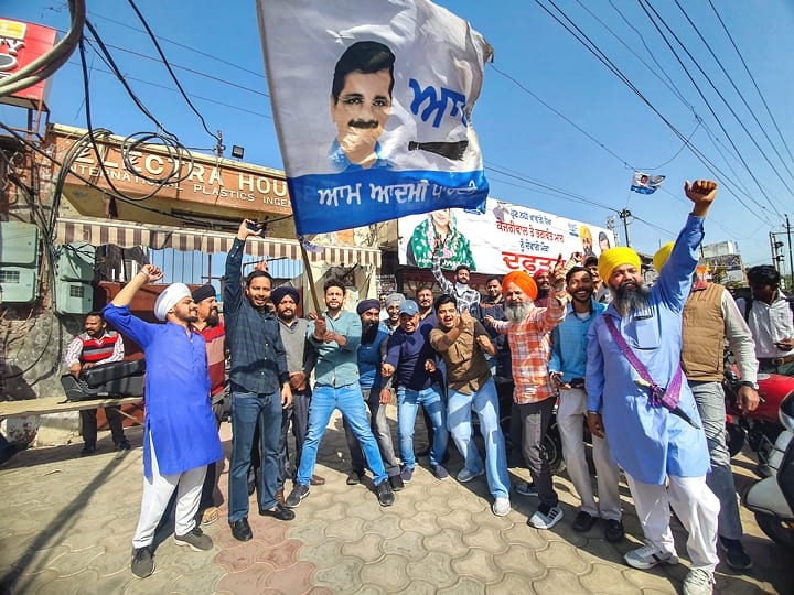 Aam Aadmi Party (AAP) supporters celebrate their party s lead during counting day of Punjab Assembly elections, in Amritsar district, Thursday, March 10, 2022. (PTI Photo)