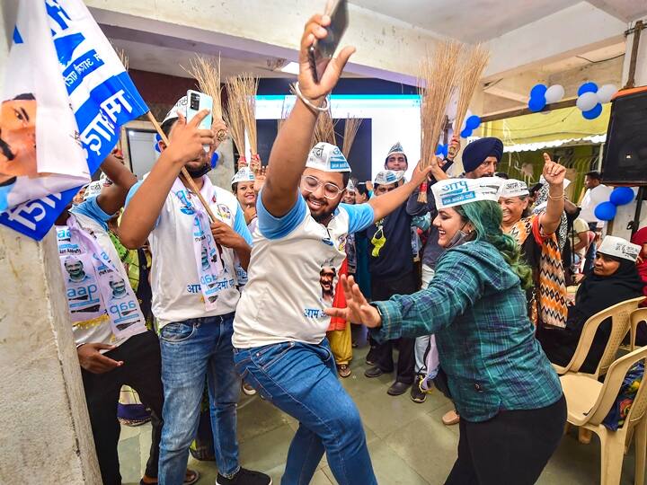 Aam Aadmi Party (AAP) workers celebrate their partys lead during counting day of Punjab elections in Mumbai, Thursday, March 10, 2022. (PTI Photo/Shashank Parade)