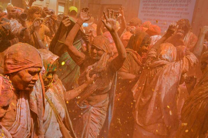 Widows play with colour in celebration of Holi during a function organised by Sulabh Hope Foundation at Gopinath Temple, in Vrindavan near Mathura, Tuesday, March 15, 2022. (Source: PTI)