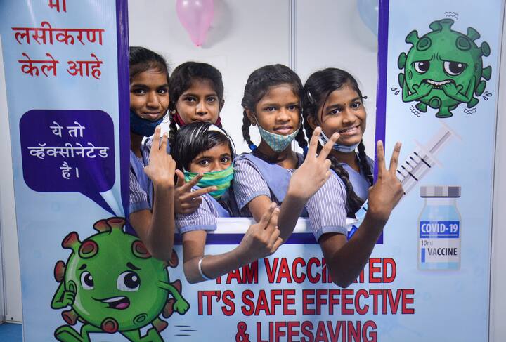 Students pose for photos after receiving a dose of Covid-19 vaccine in Maharashtra's Thane. The major issue with the vaccination is that each vial has 20 doses and to avoid wastage presence of as many children are required. (Image: PTI)