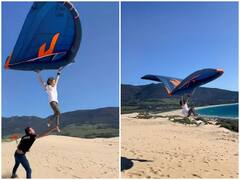 समुद्र किनारे मस्ती कर रही महिला ने की हवाई यात्रा, पैराग्लाइडर की मदद से उड़ते दिखाई दी