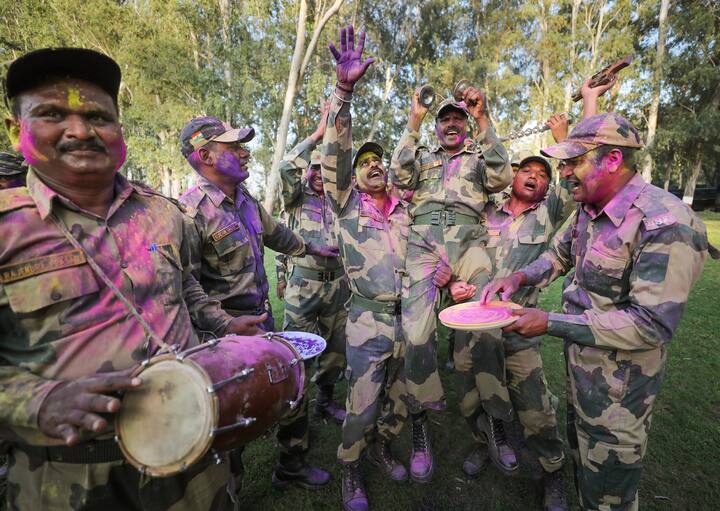 On the occasion of Holi, Indian Army organises special programmes for soldiers posted away from their families. Senior personnel also distribute sweets to their jawans and share some fun time together. (Image: PTI)