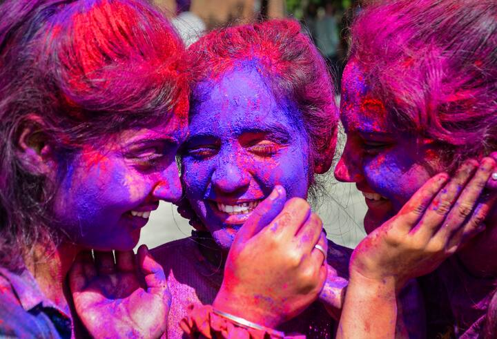 Students smear colour on each others faces, in celebration of the festival of Holi at Guru Nanak Dev University, in Amritsar. The Holi celebrations began with much fanfare amid song and dance performances. (Image: PTI)