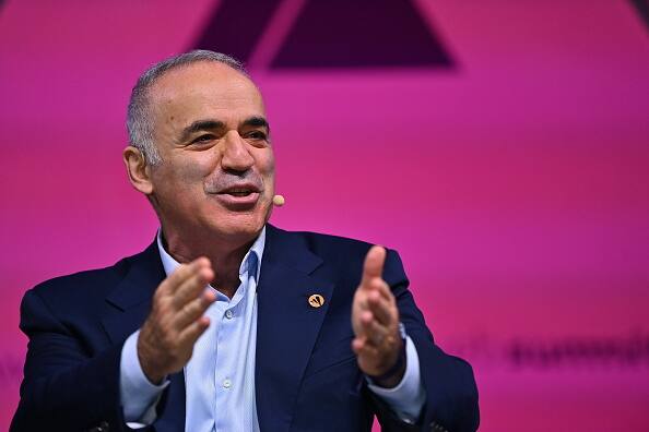 Former World Chess Champion, Garry Kasparov, right, talks to the