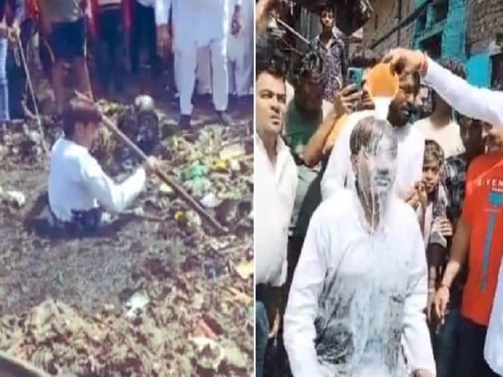 Delhi MCD Election : AAP councilor cleans up sewage drain, later supporters bath him with milk Delhi MCD Election : 'आप' नगरसेवक तुंबलेल्या गटारात उतरला, सफाईनंतर दुग्धाभिषेक