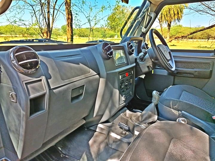 Getting inside is a task that requires exercise in itself. There is a grab rail which you have to use as it is very tall and difficult to get in. Even tall people will have to make an effort here. Once in, the interiors might seem basic at first glance but compared to the earlier ones, there is much better quality and more technology. However, do not go thinking that it matches some other similarly priced compact SUVs and you'll be fine. That said, for what is a tank on wheels, the equipment list is surprisingly good. You get a (basic) touchscreen with Android Auto/Apple CarPlay while there are front power windows, speed-sensing door locks, a tyre pressure monitoring system (near the instrument cluster which you can turn on/off), dual airbags, and rear parking sensors.