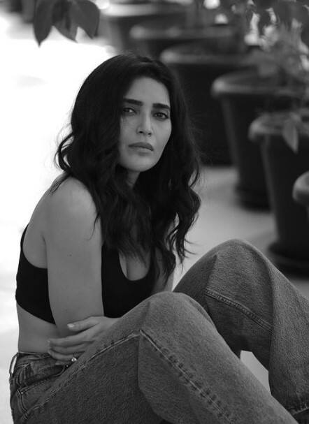 ऑफ शोल्ड व्हाइट शर्ट आणि ग्रे पँट अशा लूकमधील मोनोक्रोम फिल्टरमधील फोटो करिश्मानं शेअर केले आहेत. (Karishma Tanna/Instagram)