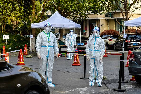 Volunteers work at a temporary Covid-19 testing site during a citywide COVID-19 nucleic acid testing campaign on April 1, 2022 in Shanghai, China. (Source: Getty Images)