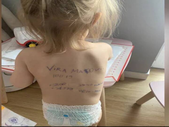 ukrine mother wrote family details on her daughte's back. this pic goes viral on socila media.! கொல்லப்படுவோம் என்ற அச்சம்.. குழந்தையின் முதுகில் குடும்ப விபரங்களை எழுதிய தாய்.. உக்ரைனில் நீளும் சோகம்!