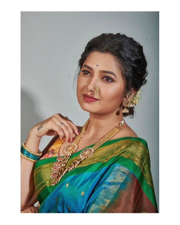 निळ्या आणि हिरव्या रंगाची साडी, गोल्डन ज्वेलरी आणि गजरा अशा लूकमधील फोटो प्राजक्तानं शेअर केले आहेत. (Prajakta Mali/instagram)