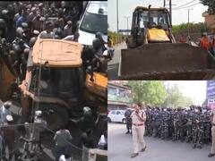 Delhi News: हिंसा के बाद जहांगीरपुरी में अवैध प्रॉपर्टी पर चला बुलडोजर, भारी सुरक्षा के बीच की जा रही कार्रवाई, देखें तस्वीरें