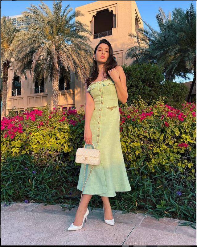 Nora Fatehi stuns in a light green dress with off-white stilettoes