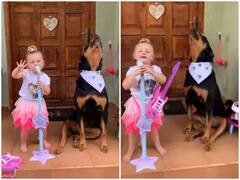 Watch: पालतू कुत्ते के साथ परफॉर्म करती नजर आई छोटी बच्ची, इंटरनेट पर छाया वीडियो