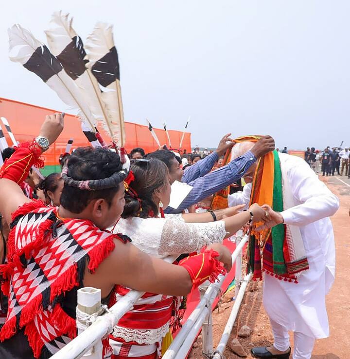 PM Modi interacts with locals during the rally at Loringthepi. At the rally, PM Modi said efforts were on to remove AFSPA completely from the northeast region. He said law and order situation had improved in the last eight years in the northeast. (Source: PTI)
